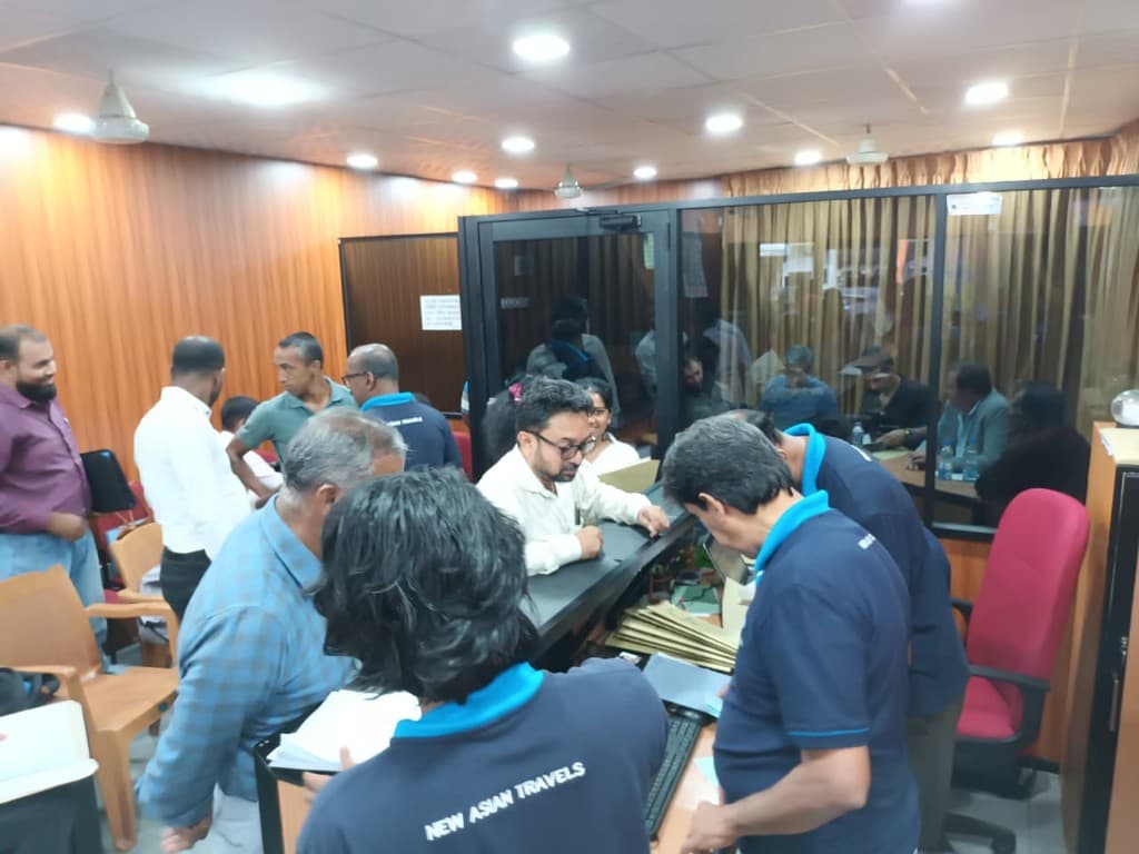 New Asian Travels staff assisting clients at the Colombo office counter